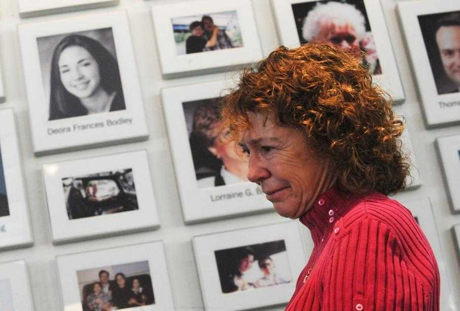 Photo of Debby at the Flight 93 National Memorial in front of the displayed photo of her daughter Deora.